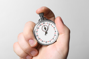 Man holding vintage timer on white background, closeup