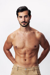 Fototapeta premium Male athlete model with naked torso and packs of abs sporty on white isolated background, trendy clothing style, copy space, space for text