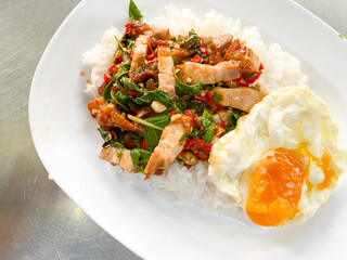 Rice topped with crispy pork belly with Thai basil and fried egg