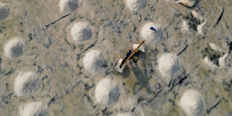 Aerial view of worker harvesting salt in salt field at Ban Laem-Thailand	