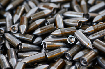 Scattered grey bullets armour ammunition as background
