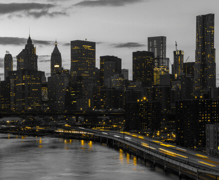 Fototapeta Yellow lights shining in black and white cityscape with the downtown Manhattan skyline buildings of New York City at night time