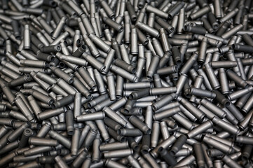 Grey shell casings in container at armor production plant