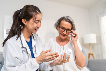 Asian caregiver nurse give consult to Caucasian senior woman patient. 