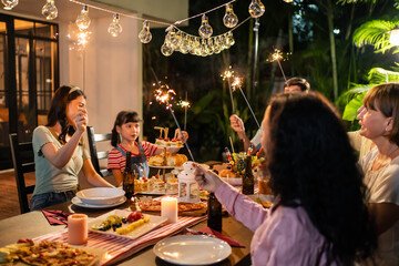 Multi-ethnic big family having fun, enjoy party outdoors in the garden. 