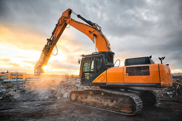 Excavator with concrete crusher at demolition site