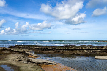 Great barrier of stones and coral on the beach of Sibauma in the northeast of Brazil.