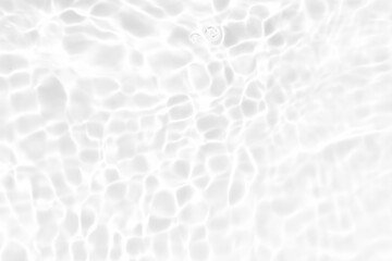 Defocus blurred transparent white colored clear calm water surface texture with splashes and bubbles. Trendy abstract nature background. Water waves in sunlight with copy space. White water shine