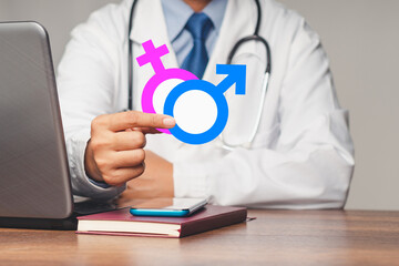 Doctor holds gender emblems for men and women while sitting in the hospital