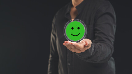 Positive feedback concept. Happy mood icon in hand while standing on a black background