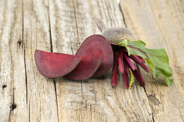 Beetroot with green leaves on grey rustic wood