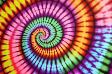 a batik spiral tie - dye pattern is shown in rainbow colors.