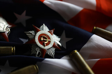 Many bullets cartridges and medals on United States flag. Concept of war glory victory. Gun...