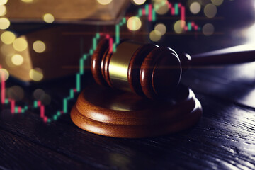 Wooden judge gavel and legal book on wooden table