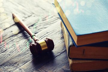 Wooden judge gavel and legal book on wooden table