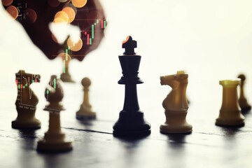 Chess game with black and white wooden chips on wooden board. At sunset. Realistic.