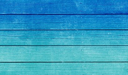 Painted wood deck floor texture background reminiscent of blue sky and mint emerald sea. There is...