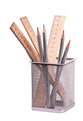Some gray pencils and wooden rulers in office support on a white
