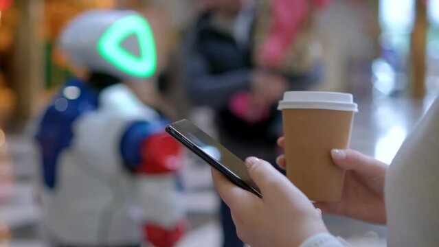 Young woman using smartphone at mall. Caucasian girl looking at mobile phone in her hand. Communication, work or study, connection, mobile apps, technology, lifestyle concept 4K
