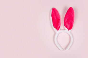 easter holiday background with bunny ears on pink background. copy space
