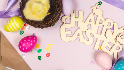 Art Happy Easter concept. Frame of Easter eggs and little yellow chicken, greeting card on pink background. Flat lay, top view, banner