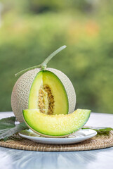 Crown Musk Melon on nature background, Shizuoka Crown Melon Yama Grade on Green bokeh background.
