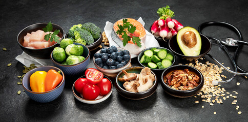 Food for a healthy heart concept and  stethoscope on black background