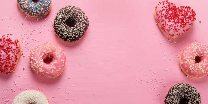 Tasty donuts on pink background. National donuts day. - Powered by Adobe