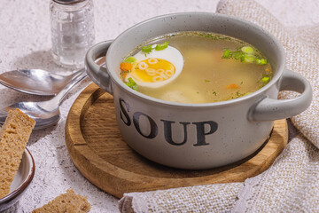 Meatball soup with boiled egg, ditalini pasta, vegetables and fresh herbs. Healthy chicken broth