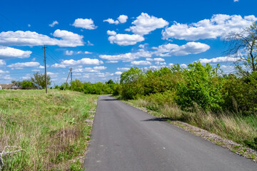 Beautiful empty asphalt road in countryside on colored background