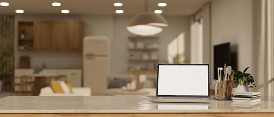 Home workspace with laptop mockup over blurred background of modern contemporary kitchen.