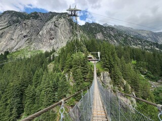 A long suspension bridge with a mountain in the background