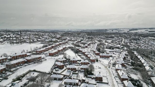 Urban Winter Scene. Aerial Drone Video Footage showing a snowy landscape in a suburban UK town.