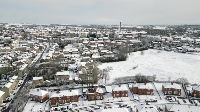 Urban Winter Scene. Aerial Drone Video Footage showing a snowy landscape in a suburban UK town.