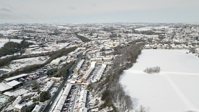 Urban Winter Scene. Aerial Drone Video Footage showing a snowy landscape in a suburban UK town.