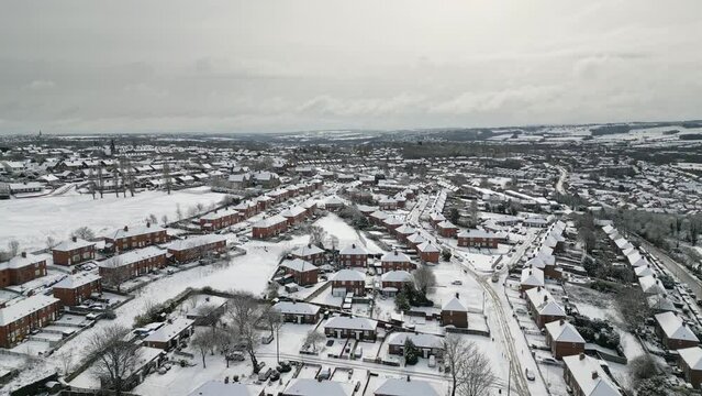 Urban Winter Scene. Aerial Drone Video Footage showing a snowy landscape in a suburban UK town.