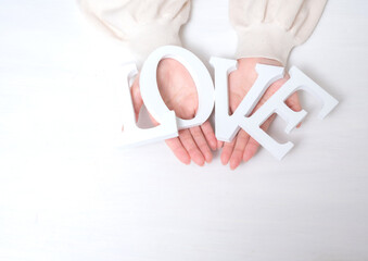 LOVEの文字を持った若い女性の手