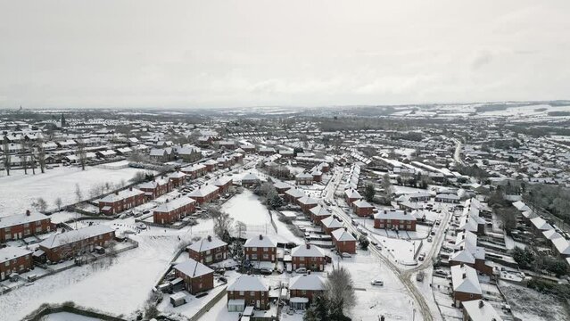 Urban Winter Scene. Aerial Drone Video Footage showing a snowy landscape in a suburban UK town.