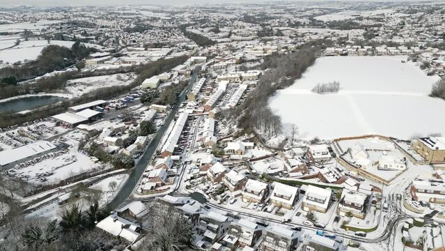Urban Winter Scene. Aerial Drone Video Footage showing a snowy landscape in a suburban UK town.