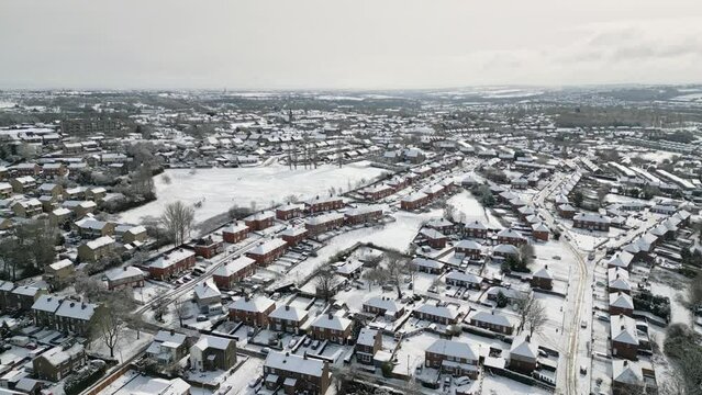 Urban Winter Scene. Aerial Drone Video Footage showing a snowy landscape in a suburban UK town.