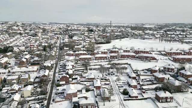 Urban Winter Scene. Aerial Drone Video Footage showing a snowy landscape in a suburban UK town.
