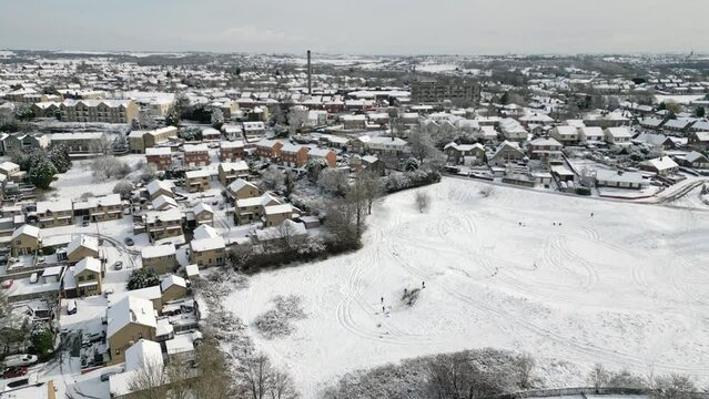 Urban Winter Scene. Aerial Drone Video Footage showing a snowy landscape in a suburban UK town.