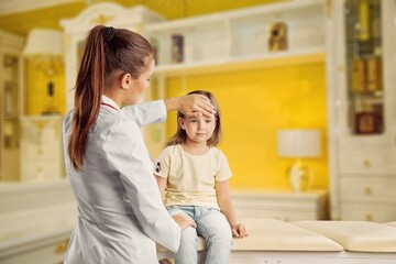 Woman doctor examining little girl