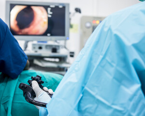 A doctor or surgeon in a light blue protective gown did a colonoscopy or gastroscopy inside...
