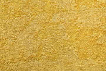 Texture of a yellow terry fabric as an abstract background