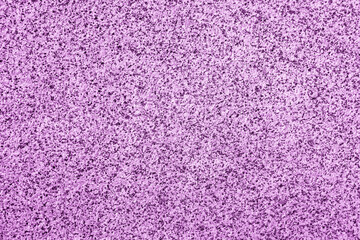 Closeup of a granite stone surface colored in light purple as a background
