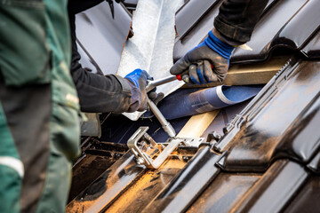 Fastening a bracket for a solar panel mounting system to a roof