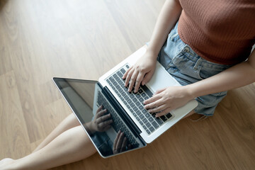 Fototapeta premium Woman Working by using laptop blank screen computer . Hands typing on a keyboard.technology e-commerce concept.