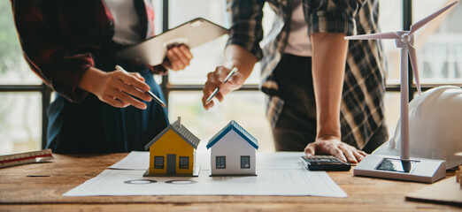 Engineer teams meeting working together wear worker helmets hardhat on construction site in modern city.