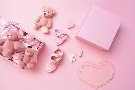 Show off your love for your baby girl with this top view photo of pink gift boxes, booties, and a variety of cute toys, including a teddy bear and pacifier, on an isolated pastel pink background